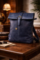 Blue leather backpack on a wooden table with a warm, indoor setting.